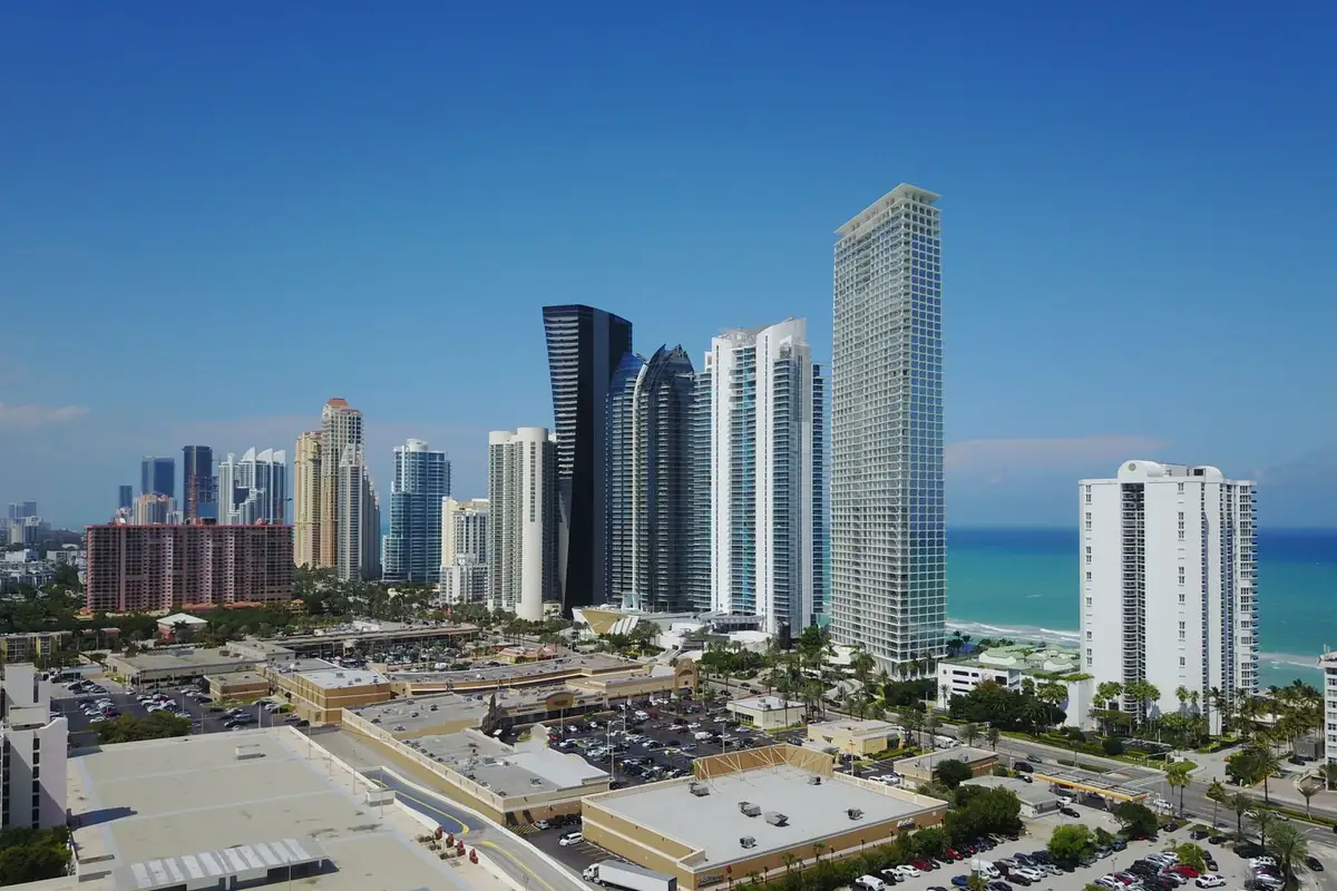 Row of high-rise towers along the ocean in Sunny Isles Beach on a clear day